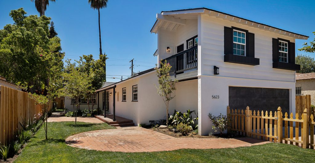 Exterior of home with picket fence. 